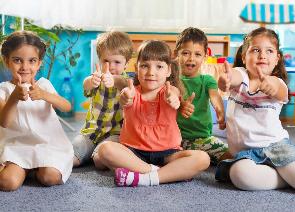  children sitting on the floor with their thumbs up. https://stepmomcoach.com/blog/