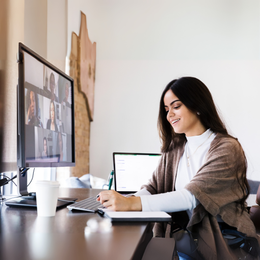 Woman sitting at computer screen taking notes. The Resilient Stepmom Blueprint program